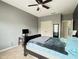 Spacious bedroom with a gray wall, carpet floor and white doors, featuring a ceiling fan at 4769 Moon Hollow Ct, Buford, GA 30519