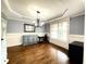 Dining room with hardwood floors, chandelier, wainscoting, and natural light at 4769 Moon Hollow Ct, Buford, GA 30519