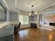 Formal dining room featuring chandelier, wainscoting and hardwood floors at 4769 Moon Hollow Ct, Buford, GA 30519