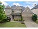 Charming brick two-story home featuring a manicured lawn, tidy landscaping and attached two car garage at 4769 Moon Hollow Ct, Buford, GA 30519