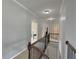 Second floor hallway featuring wrought iron railings and hardwood floors at 4769 Moon Hollow Ct, Buford, GA 30519