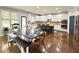Bright eat-in kitchen featuring an island with seating, stainless steel appliances, and hardwood floors at 4769 Moon Hollow Ct, Buford, GA 30519