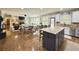 Open concept kitchen with white cabinets, large island, hardwood floors and stainless steel appliances at 4769 Moon Hollow Ct, Buford, GA 30519