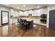 Spacious kitchen featuring an island with seating, stainless steel appliances, and hardwood floors at 4769 Moon Hollow Ct, Buford, GA 30519
