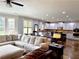 Open concept living area with large sectional sofa, kitchen, and natural light at 4769 Moon Hollow Ct, Buford, GA 30519