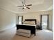 Spacious main bedroom featuring a tray ceiling, carpeted floors, and neutral decor at 4769 Moon Hollow Ct, Buford, GA 30519