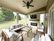 Outdoor screened-in patio with comfortable seating, a fireplace, and a ceiling fan at 4769 Moon Hollow Ct, Buford, GA 30519