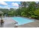 Community pool featuring a splashpad, zero entry, chaise lounges and mature trees at 4769 Moon Hollow Ct, Buford, GA 30519