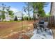Fenced backyard featuring a patio area with outdoor seating and a peaceful green space at 1539 Creek Bend Ln, Lawrenceville, GA 30043