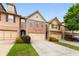 Charming townhome featuring a brick front, attached garage, and well-manicured landscaping at 1539 Creek Bend Ln, Lawrenceville, GA 30043