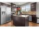 Well-lit kitchen with stainless steel appliances, dark cabinetry, and a functional island with granite countertops at 1539 Creek Bend Ln, Lawrenceville, GA 30043