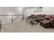 Second-floor living room featuring a sectional sofa and easy access to the stairway at 1539 Creek Bend Ln, Lawrenceville, GA 30043