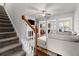 Open-concept living room with a fireplace and hardwood floors, adjacent to the kitchen at 1539 Creek Bend Ln, Lawrenceville, GA 30043