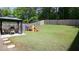 Expansive backyard featuring lush green grass, a playset, a privacy fence, and a gazebo with outdoor seating at 156 Woodhouse Cir, Acworth, GA 30102