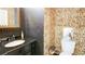Unique powder room featuring an oval sink with an ornate mirror and playful wallpaper at 156 Woodhouse Cir, Acworth, GA 30102