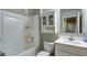 Bright bathroom features a shower-tub, modern vanity with integrated sink, and built-in cabinet for ample storage at 156 Woodhouse Cir, Acworth, GA 30102