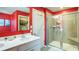 Bathroom with modern vanity, a glass-enclosed shower, and bold red walls, blending style and functionality at 156 Woodhouse Cir, Acworth, GA 30102