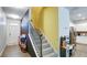 Inviting entryway with a staircase, colorful decor, and a glimpse into the modern kitchen at 156 Woodhouse Cir, Acworth, GA 30102