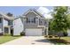 Charming two-story home with gray siding, a two-car garage, and well-maintained landscaping at 156 Woodhouse Cir, Acworth, GA 30102