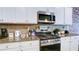 Well-equipped kitchen features granite countertops and stainless steel appliances at 156 Woodhouse Cir, Acworth, GA 30102