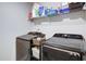 Convenient laundry room with shelving, washer, and dryer units at 156 Woodhouse Cir, Acworth, GA 30102
