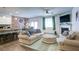 Cozy living room with comfortable sofas, a fireplace, and an open layout to the kitchen at 156 Woodhouse Cir, Acworth, GA 30102