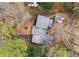 Aerial view of the home showing the roof and surrounding mature trees, including an outbuilding at 2325 Lago Dr, Jonesboro, GA 30236