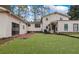 Large backyard featuring a spacious lawn, and a patio area, perfect for outdoor gatherings at 2325 Lago Dr, Jonesboro, GA 30236