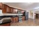 Spacious kitchen features dark cabinets, granite countertops, stainless steel appliances, and tile floors at 2325 Lago Dr, Jonesboro, GA 30236