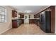The spacious kitchen features dark cabinets, stainless steel appliances, and tile floors at 2325 Lago Dr, Jonesboro, GA 30236