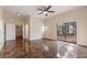 Bright living room with a ceiling fan, tiled floor, and sliding glass doors to the backyard at 2325 Lago Dr, Jonesboro, GA 30236