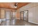 Bright sunroom boasts wood paneling, multiple windows, and sliding glass doors at 2325 Lago Dr, Jonesboro, GA 30236