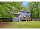 View of the home's backyard and wooden deck from the lush lawn at 295 N Fayette Dr, Fayetteville, GA 30214