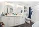 Bathroom with a white double sink vanity with marble top, dual round mirrors, and a shower at 295 N Fayette Dr, Fayetteville, GA 30214