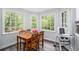 Bright eat-in kitchen featuring a wood table, chairs, and large windows at 295 N Fayette Dr, Fayetteville, GA 30214