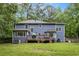 Back exterior of a two-story home with a deck and backyard at 295 N Fayette Dr, Fayetteville, GA 30214