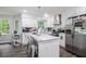 Modern kitchen with stainless steel appliances, bright lighting and a marble island with seating at 295 N Fayette Dr, Fayetteville, GA 30214