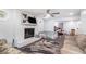 Spacious living room featuring brick fireplace, ceiling fan, wood floors and large windows at 295 N Fayette Dr, Fayetteville, GA 30214