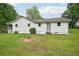 Backyard view of home featuring white siding and spacious yard at 6648 Florence Dr, Lithia Springs, GA 30122