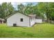 Backyard view of home featuring white siding and spacious yard at 6648 Florence Dr, Lithia Springs, GA 30122
