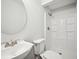 Contemporary bathroom with a tiled stand-up shower, modern faucet, and round mirror at 6648 Florence Dr, Lithia Springs, GA 30122