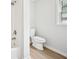 Clean bathroom features tiled shower, neutral paint and fixtures, and updated toilet at 6648 Florence Dr, Lithia Springs, GA 30122