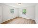 Inviting bedroom features neutral walls, two windows, and wood-look flooring at 6648 Florence Dr, Lithia Springs, GA 30122