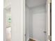 Walk-in closet with open door showcasing neutral colored walls and base molding at 6648 Florence Dr, Lithia Springs, GA 30122