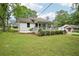 Lovely single-story home featuring a cozy covered front porch and lush green lawn at 6648 Florence Dr, Lithia Springs, GA 30122