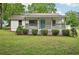Charming single-story home with a welcoming front porch and well-maintained lawn at 6648 Florence Dr, Lithia Springs, GA 30122