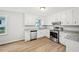 Well-lit kitchen boasts stainless steel appliances, white cabinets, and granite countertops at 6648 Florence Dr, Lithia Springs, GA 30122
