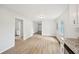 Spacious living room with an open floorplan, light wood-look flooring, and freshly painted walls at 6648 Florence Dr, Lithia Springs, GA 30122