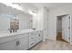 The bright bathroom includes double sink vanity, and a tiled shower with glass door at 1610 Savoy Way Way, Loganville, GA 30052