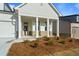 Detailed view of a charming home's columned front porch and stone accents at 1610 Savoy Way Way, Loganville, GA 30052